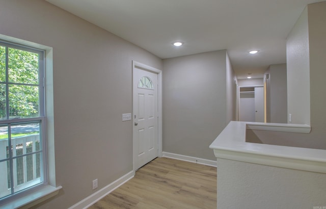 foyer entrance with light wood-type flooring