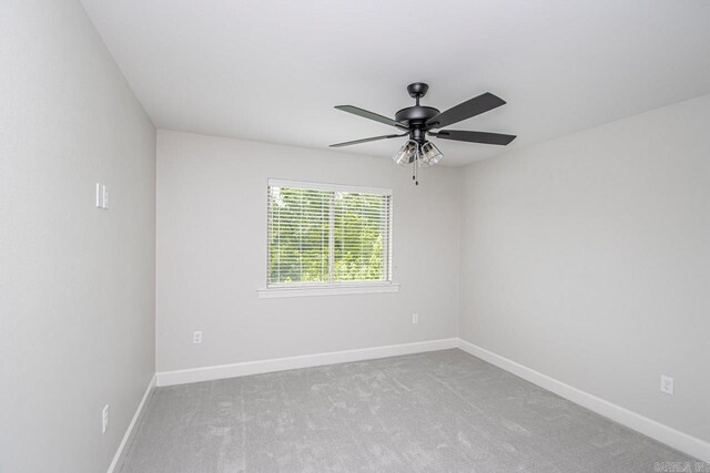 empty room with light carpet and ceiling fan