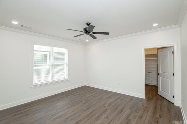 empty room featuring ceiling fan, dark hardwood / wood-style flooring, and ornamental molding