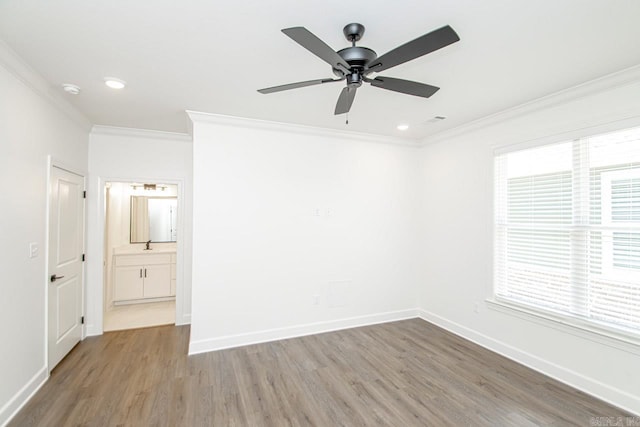 spare room with ceiling fan, hardwood / wood-style floors, and ornamental molding