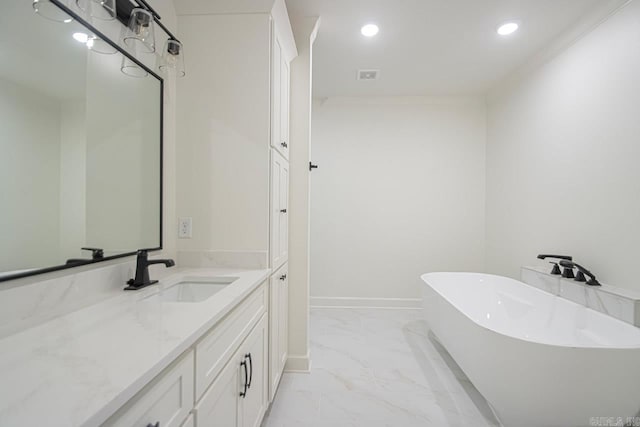 bathroom with a bathing tub, vanity, and crown molding