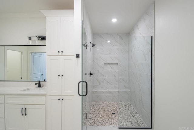 bathroom with vanity, crown molding, and walk in shower