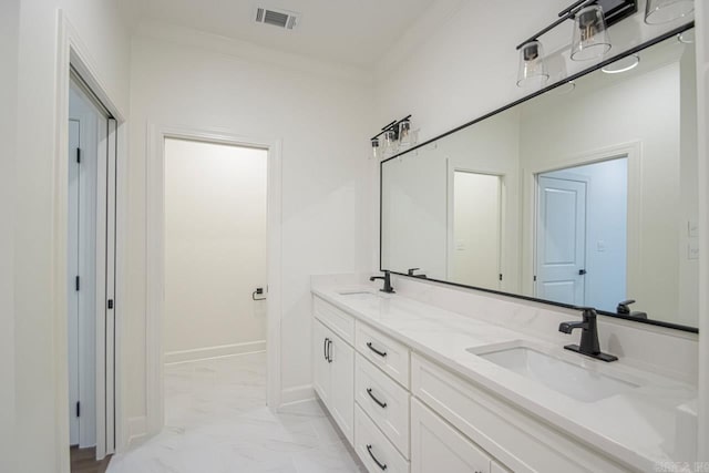 bathroom with crown molding and vanity