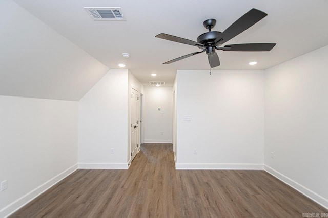 additional living space featuring hardwood / wood-style floors, ceiling fan, and lofted ceiling