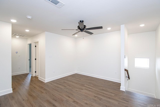 unfurnished room with ceiling fan and dark wood-type flooring