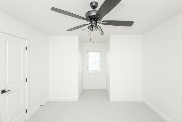 empty room featuring light colored carpet and ceiling fan