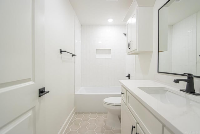 full bathroom with tile patterned flooring, vanity, tiled shower / bath combo, and toilet