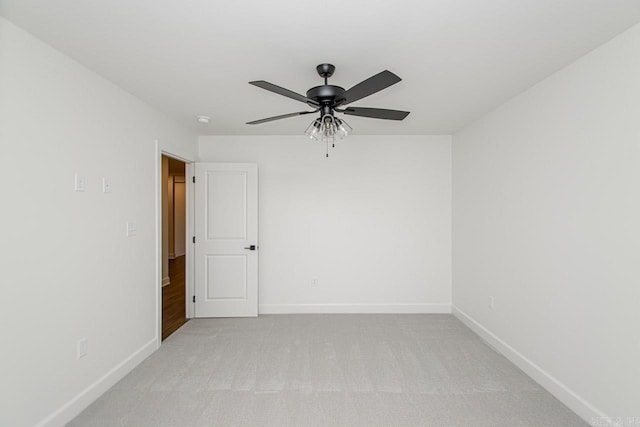 empty room featuring light carpet and ceiling fan