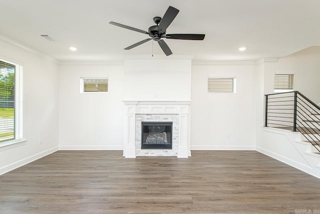 unfurnished living room with plenty of natural light, ceiling fan, dark hardwood / wood-style floors, and a fireplace