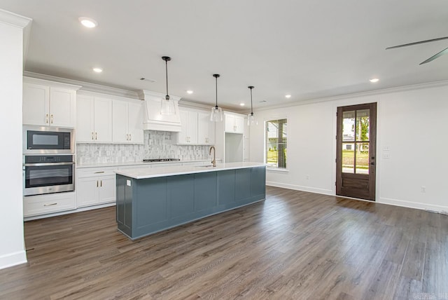 kitchen featuring white cabinetry, an island with sink, and stainless steel appliances