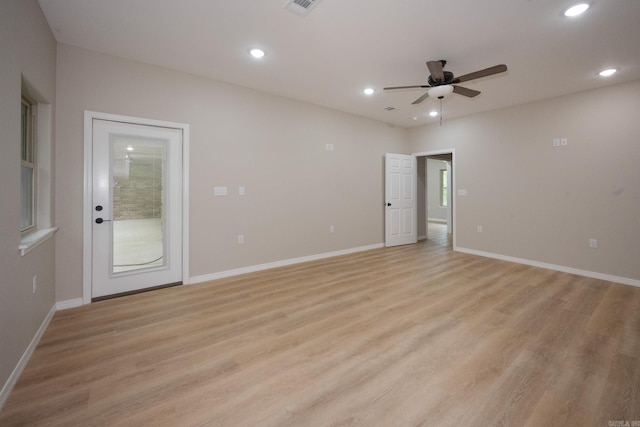 spare room with light hardwood / wood-style flooring and ceiling fan