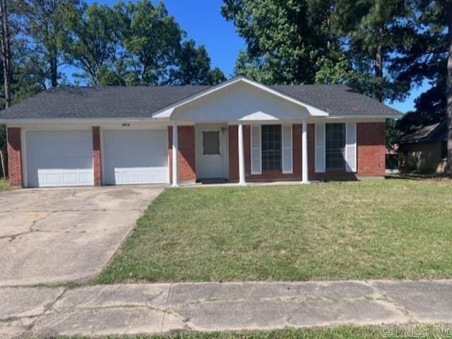 single story home featuring covered porch, a garage, and a front lawn