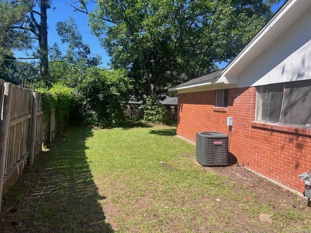 view of yard featuring central air condition unit