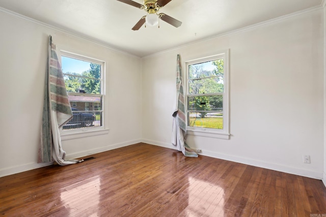 empty room featuring hardwood / wood-style flooring, ceiling fan, and ornamental molding