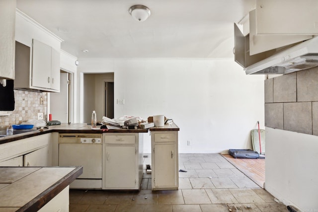 kitchen featuring dishwasher, crown molding, and tasteful backsplash