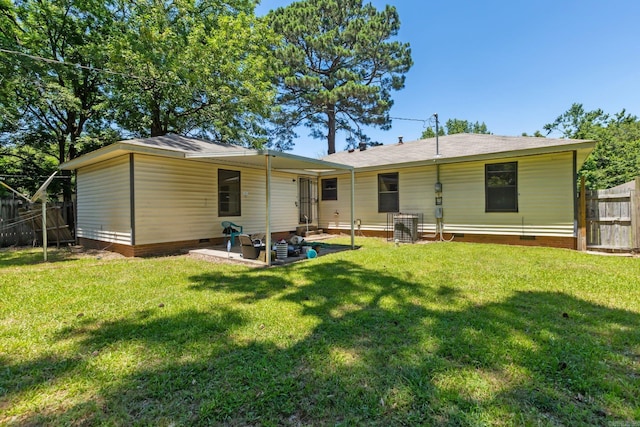 rear view of property with a patio area and a lawn