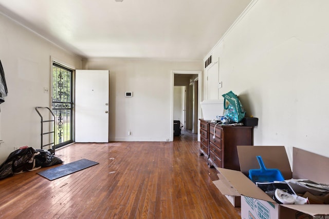 interior space featuring dark hardwood / wood-style flooring and ornamental molding