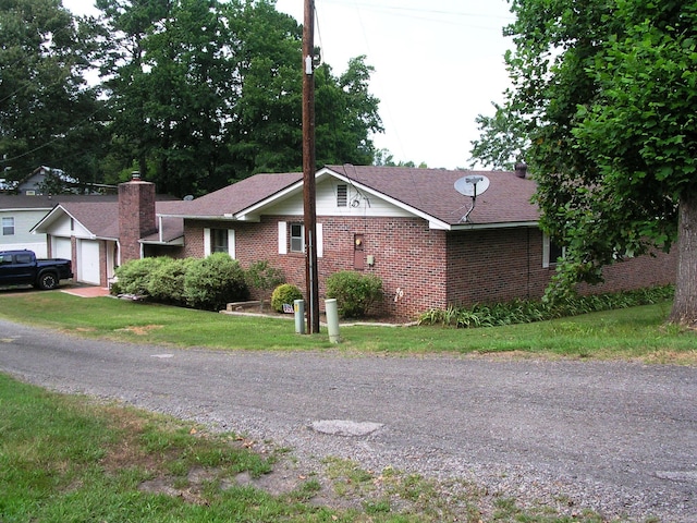 exterior space with a garage and a front lawn