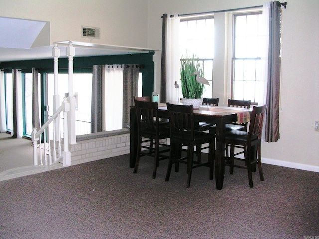 carpeted dining room featuring a wealth of natural light