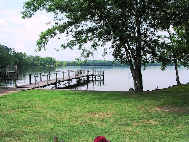 dock area featuring a water view and a yard