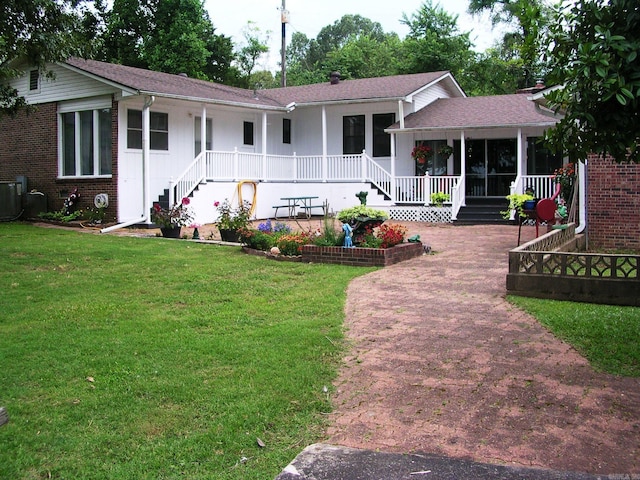 ranch-style house featuring a porch and a front yard