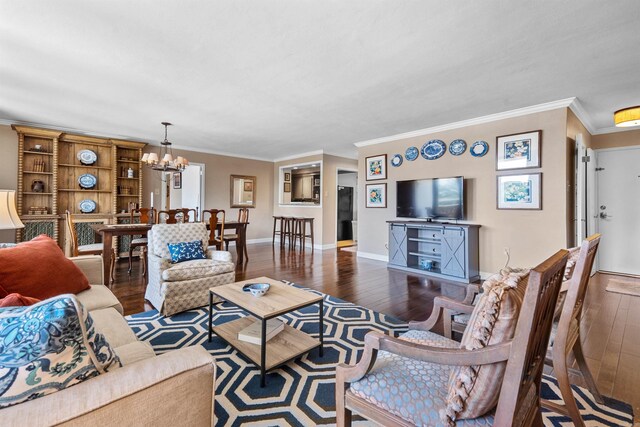 living room with dark hardwood / wood-style flooring, crown molding, and a chandelier