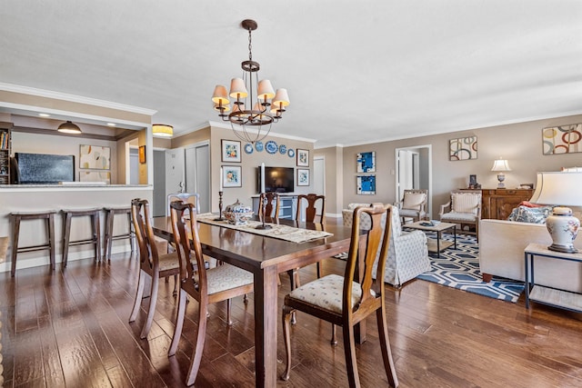 dining space featuring ornamental molding, dark hardwood / wood-style flooring, and a chandelier