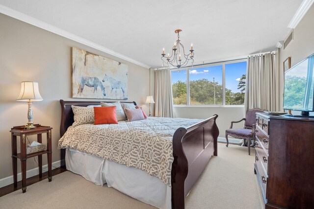 bedroom featuring crown molding, light colored carpet, and a chandelier