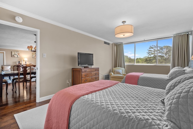 bedroom with dark hardwood / wood-style flooring and crown molding