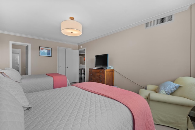 bedroom with crown molding and a closet