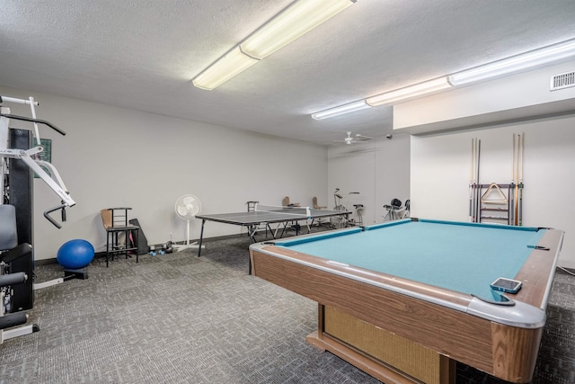 recreation room featuring a textured ceiling and carpet