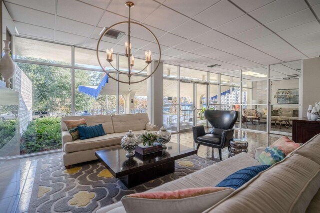 sunroom / solarium with a paneled ceiling and a chandelier