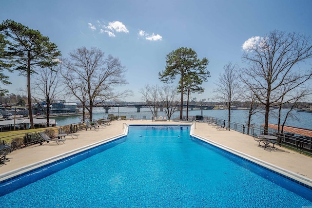 view of pool featuring a patio and a water view