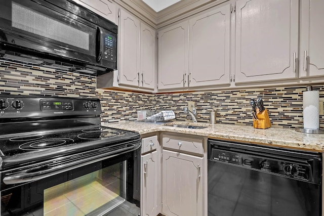 kitchen featuring sink, decorative backsplash, black appliances, and white cabinets