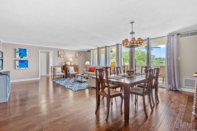 dining space featuring floor to ceiling windows, dark hardwood / wood-style floors, and a notable chandelier