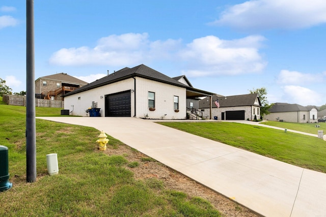 view of front of property featuring concrete driveway, a garage, a front lawn, and fence