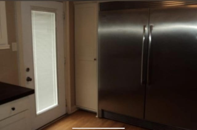 kitchen featuring white cabinetry, light hardwood / wood-style flooring, and built in refrigerator