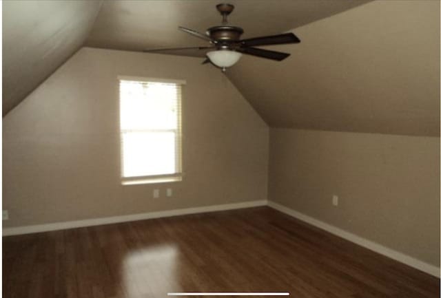 bonus room featuring dark wood-type flooring, ceiling fan, and vaulted ceiling