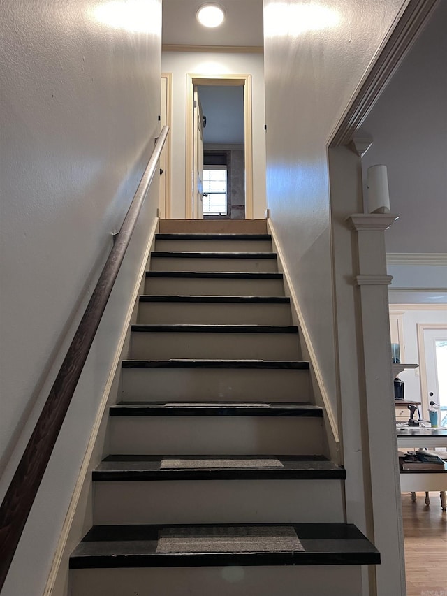 staircase with crown molding