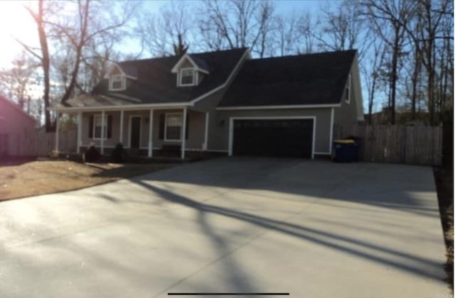 cape cod-style house with a porch and a garage