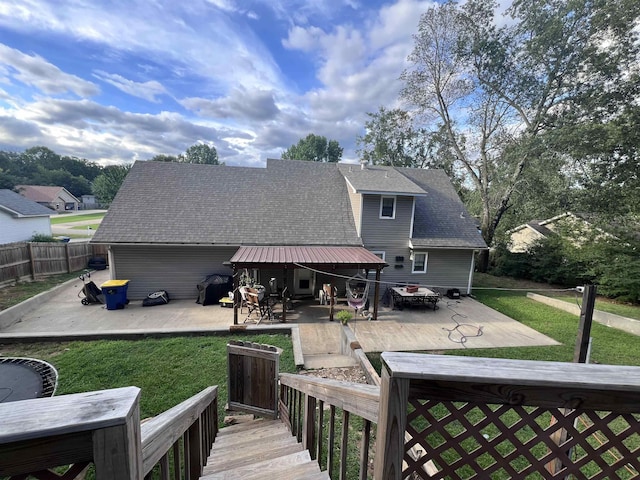 rear view of property featuring a patio area and a lawn