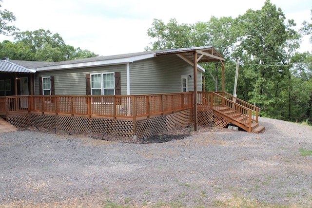 view of side of home with a wooden deck