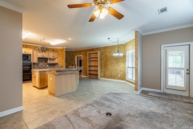 kitchen with black microwave, a kitchen island, and ornamental molding