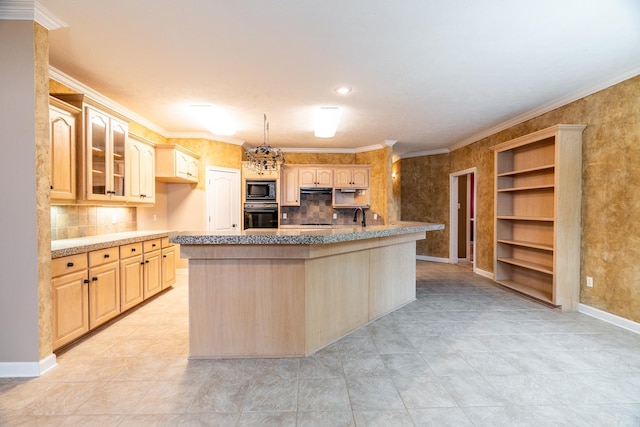 kitchen with built in microwave, a kitchen island with sink, light brown cabinets, and oven