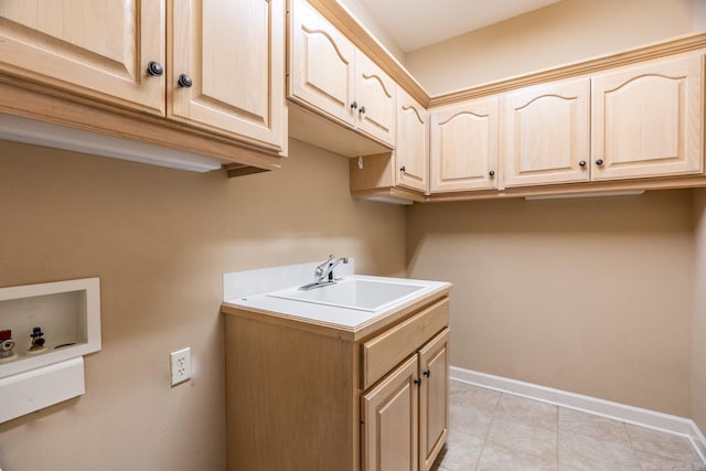 laundry room with cabinets, hookup for a washing machine, and sink