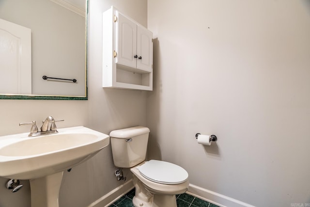 bathroom with tile patterned flooring, toilet, and sink