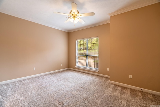 carpeted empty room featuring ceiling fan and crown molding