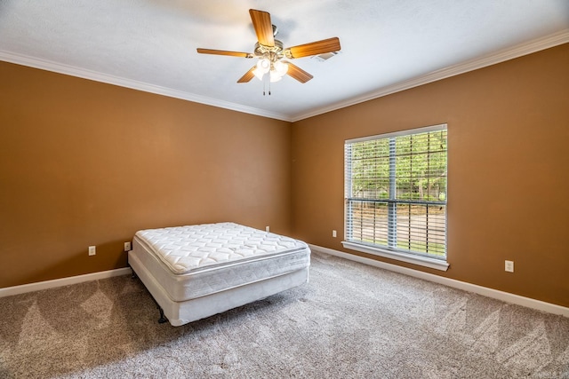 bedroom with ceiling fan, carpet, and ornamental molding