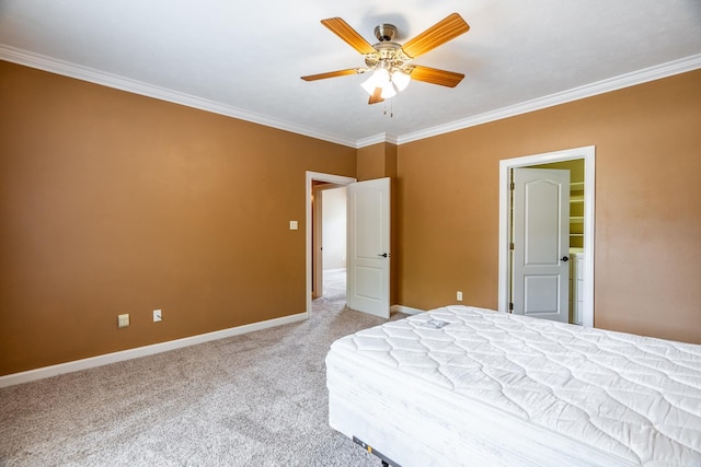 bedroom with ceiling fan, light carpet, a spacious closet, and ornamental molding