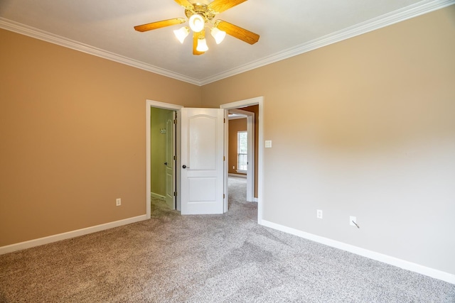 empty room with carpet, ceiling fan, and crown molding